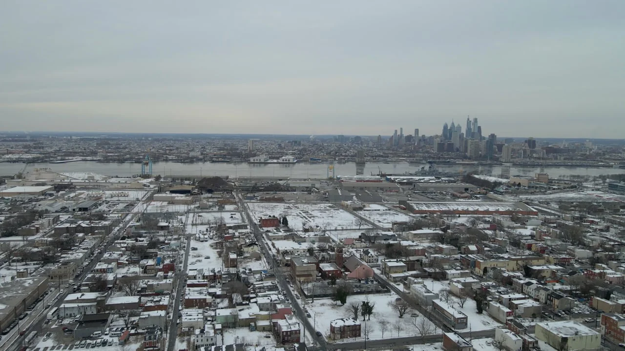 Aerial view of a snowy city and skyline from the KIPP / PILOT film.
