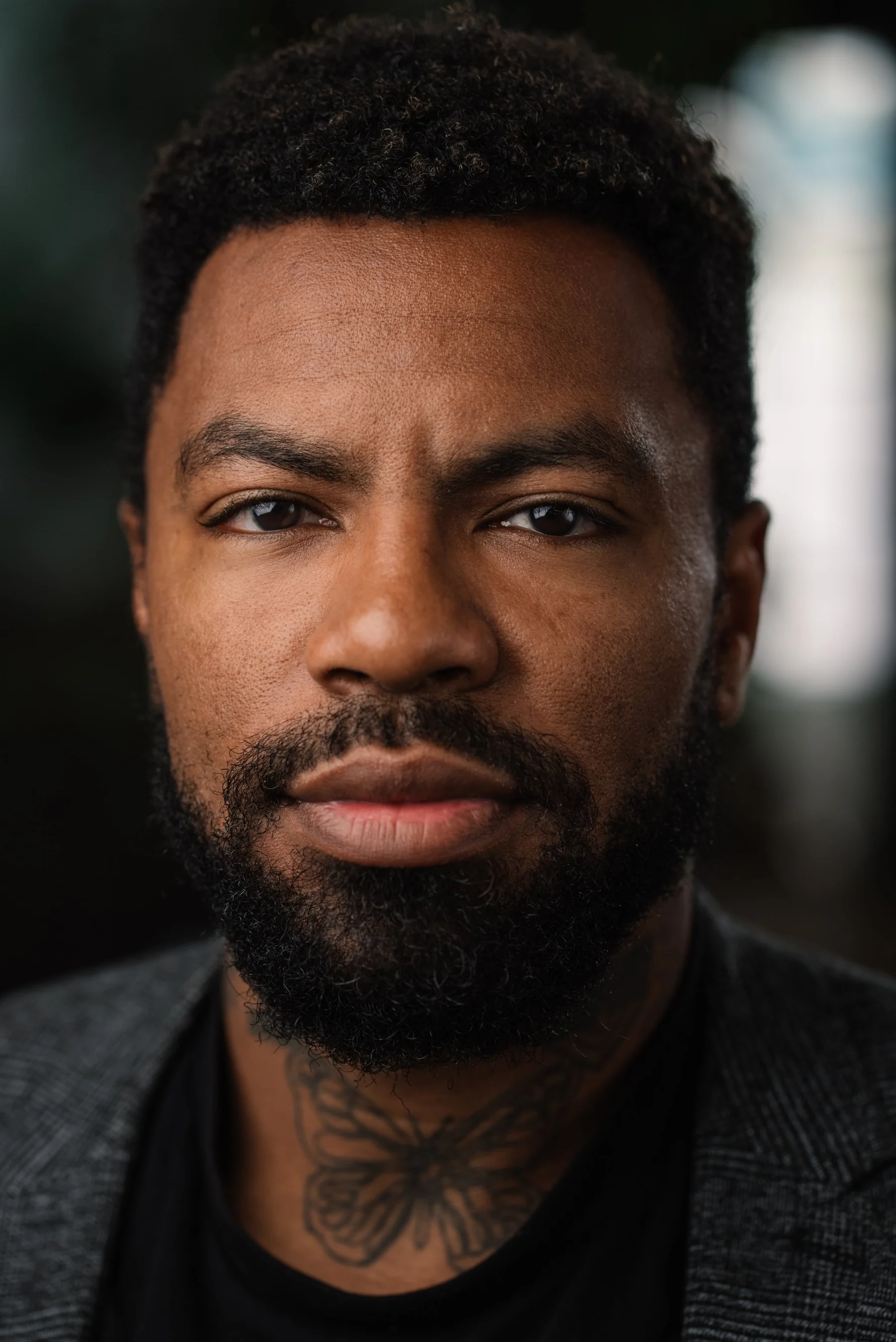 Live Free USA headshot: Subject wearing a dark shirt and gray cardigan.