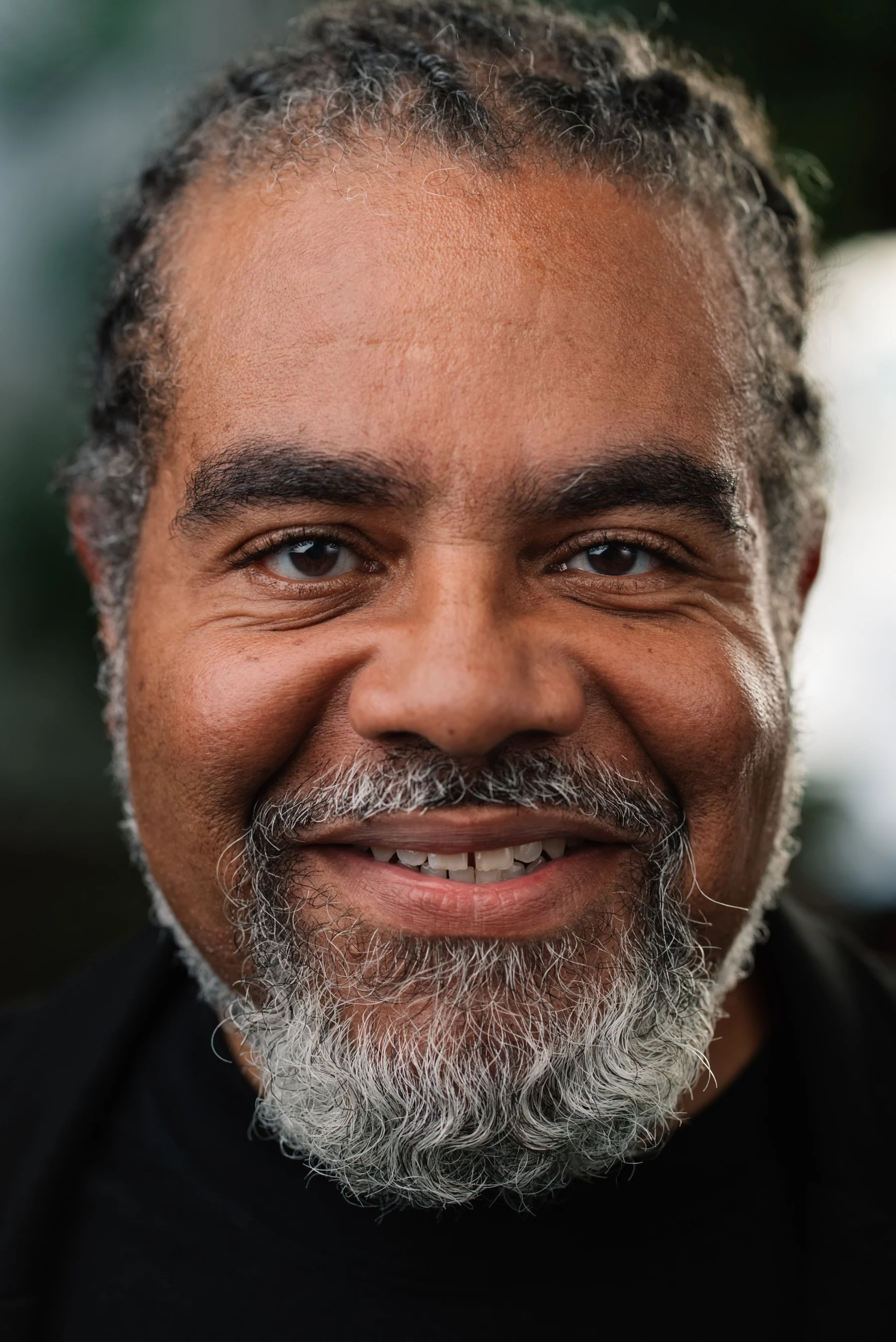 Live Free USA headshot: Subject with a gray beard wearing a black shirt.