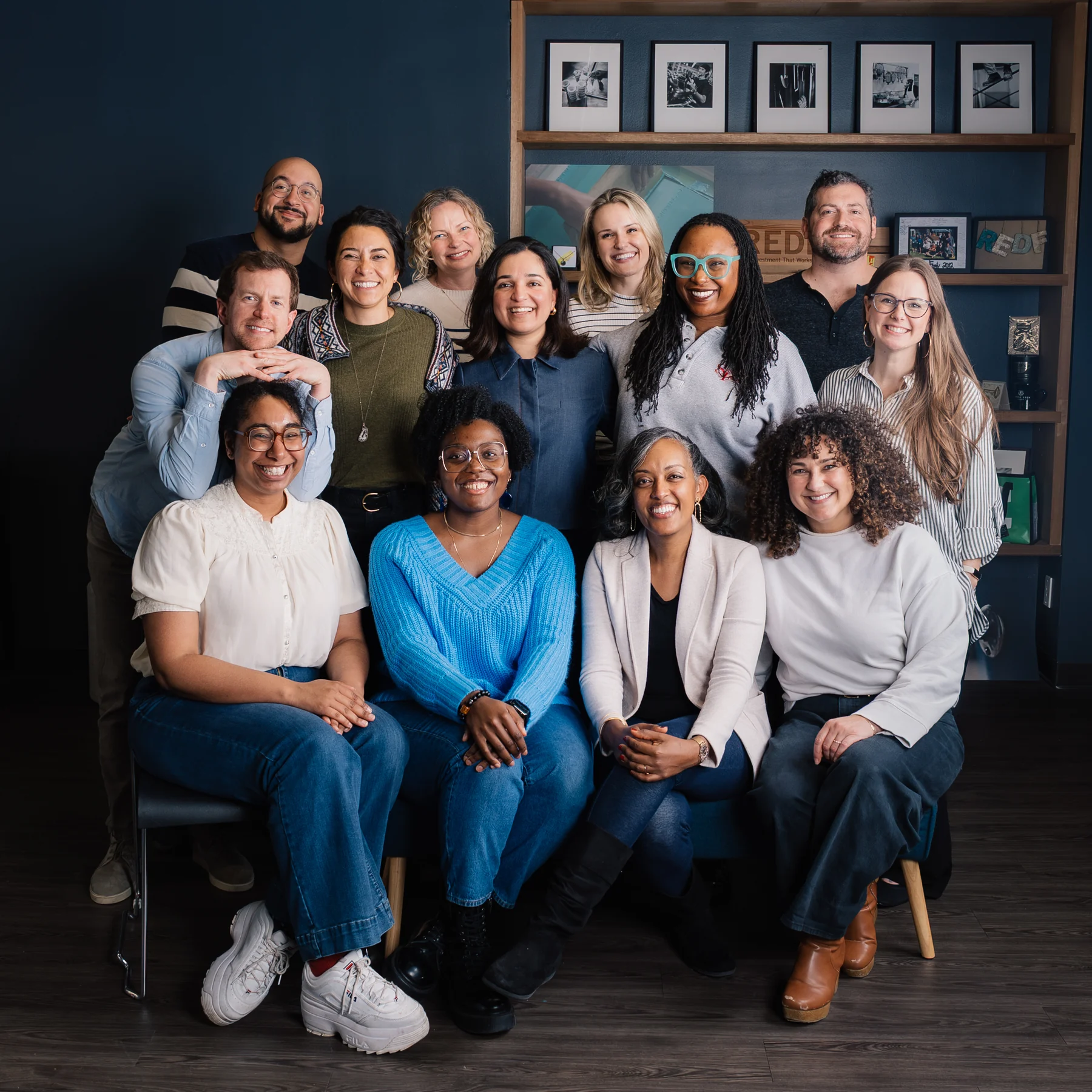 Redefine Alliance team members seated and standing together for a group portrait.