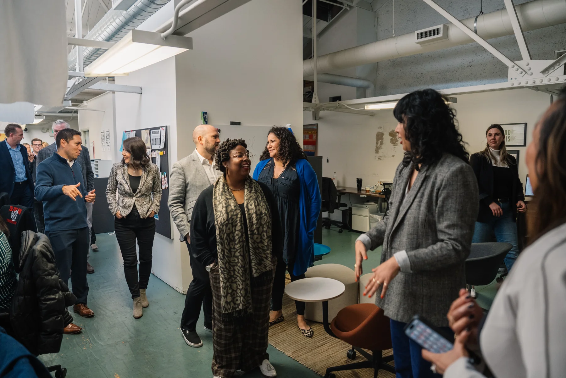 Attendees talk together while moving through the event space.