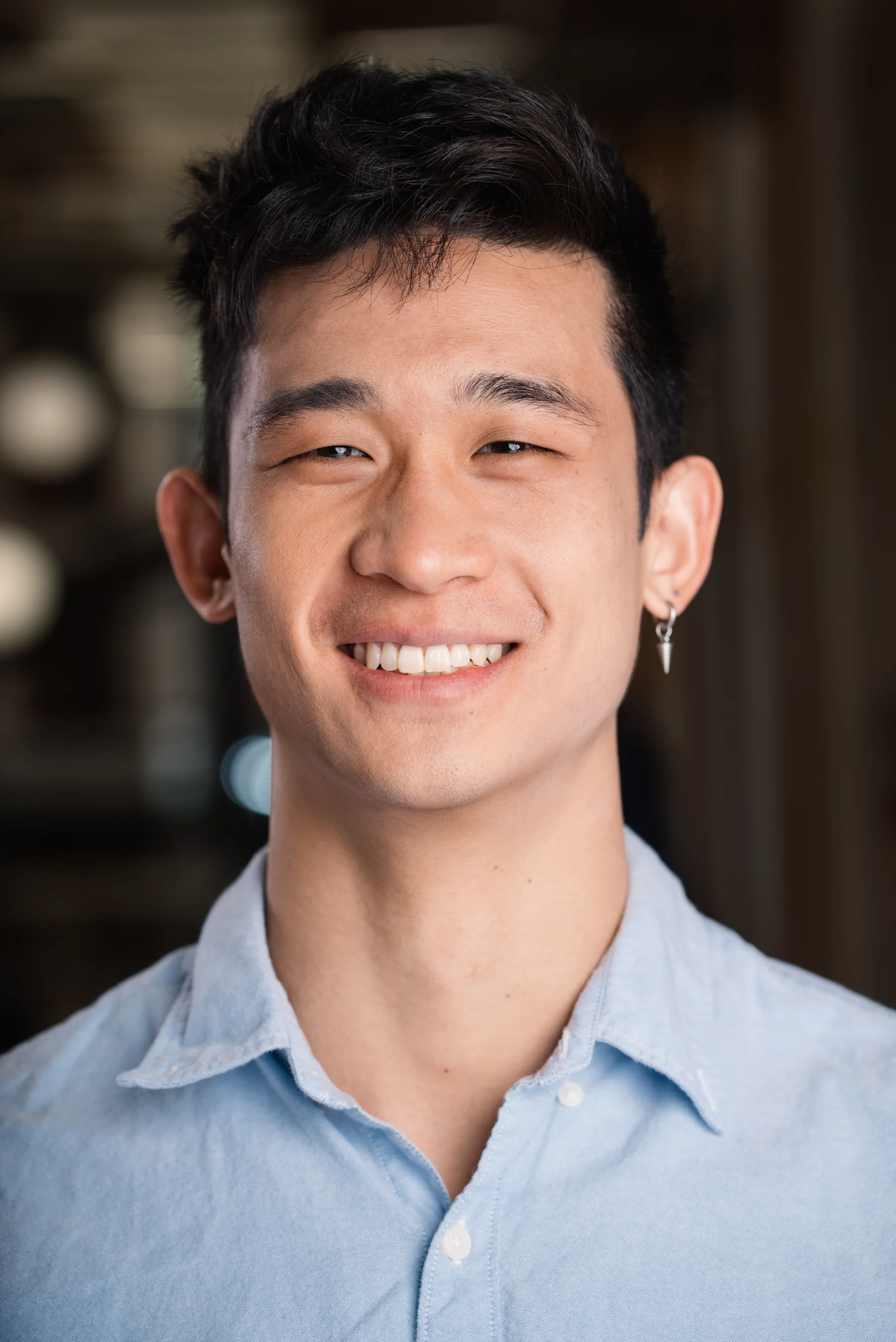 Smiling Searchlight team member in a light blue shirt.