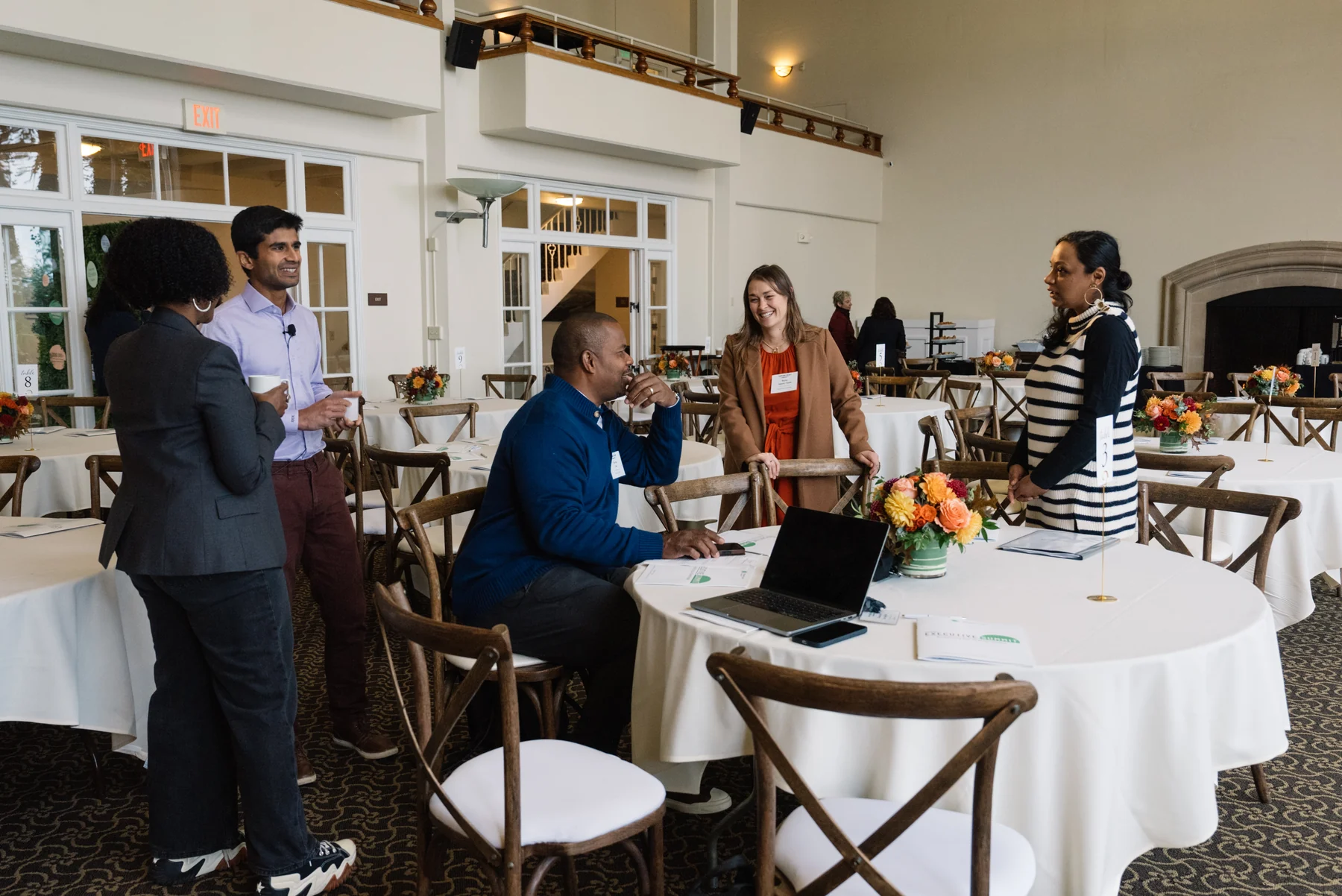 A group gathering around a table for discussion in the summit’s light-filled meeting room.
